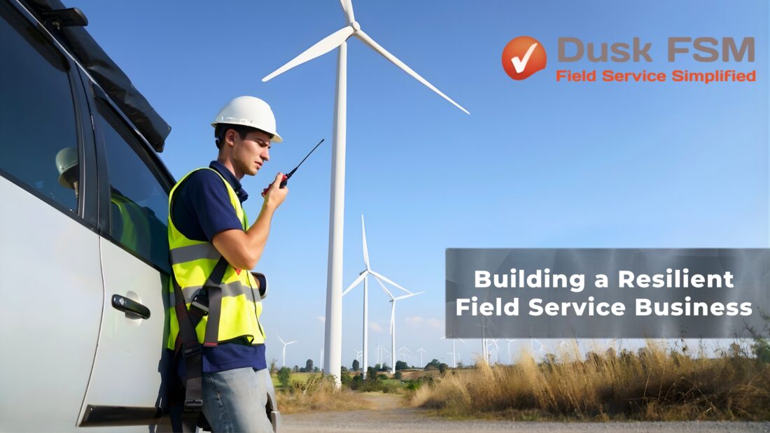 An image showing a field Technician next to a wind turbine.